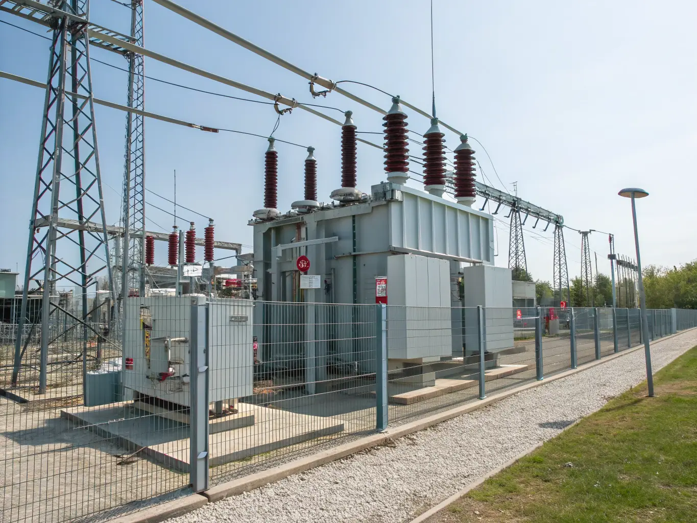 A photograph of a power distribution substation with various transformers and electrical equipment, highlighting the complexity and reliability of power solutions.